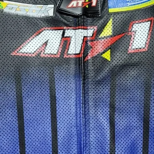 Perforated leather panel with embroidered AT1 logo