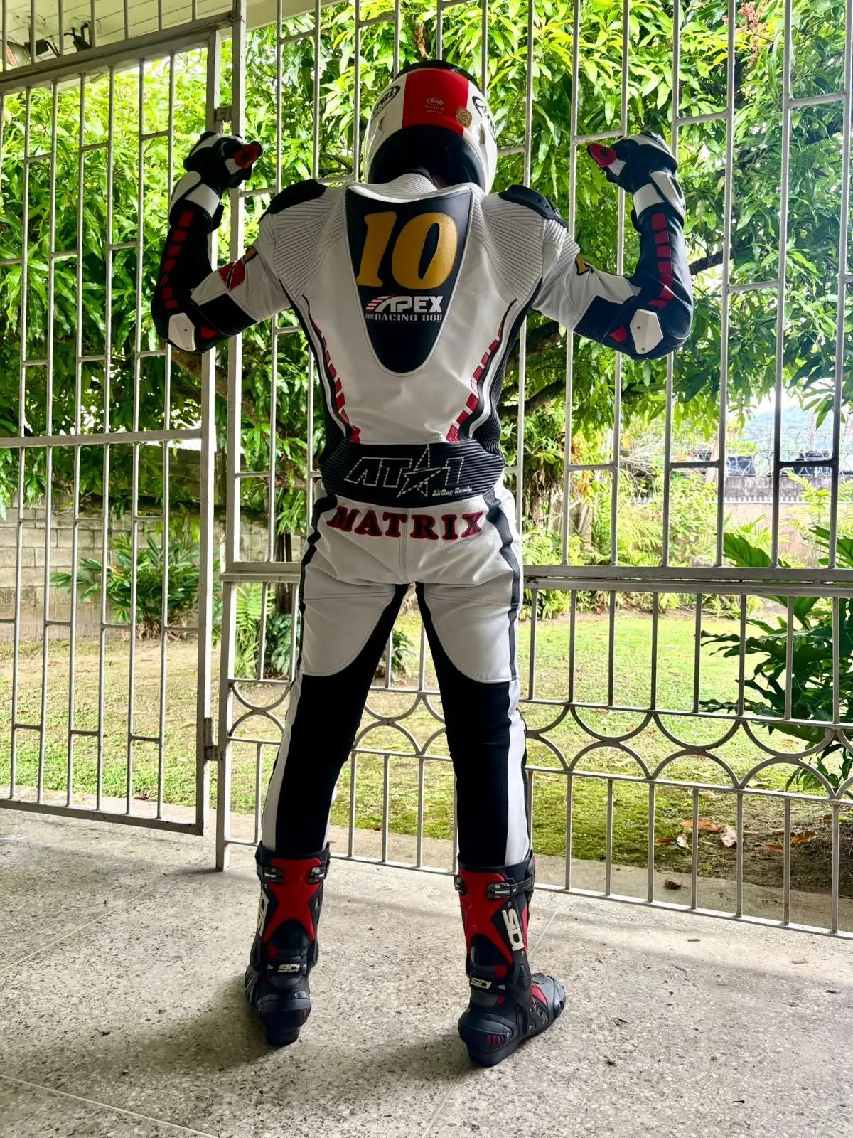 Back view of a white navy and red custom AT1 suit with number 10 Apex Racing livery
