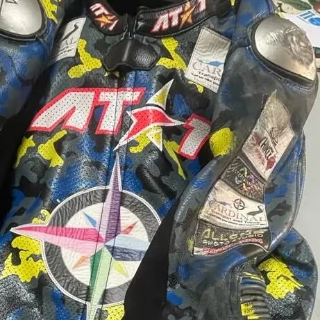Crash-tested AT1 suit showing scuffed sliders after a slide